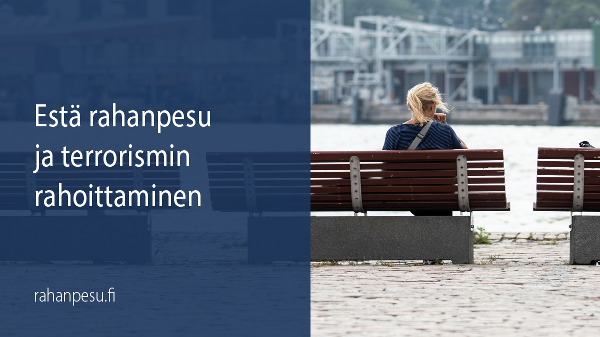 Woman sits on a bench on the seaboard with her back facing the photographer and looks towards the harbour building.